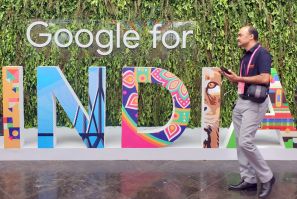 A man walks past the sign of "Google for India", the company's annual technology event in New Delhi
