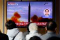 People watch a TV broadcasting a news report on North Korea firing a ballistic missile off its east coast, in Seoul