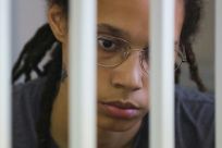 Basketball star Brittney Griner waits for the verdict inside a defendants' cage during a hearing in Khimki outside Moscow in August 2022