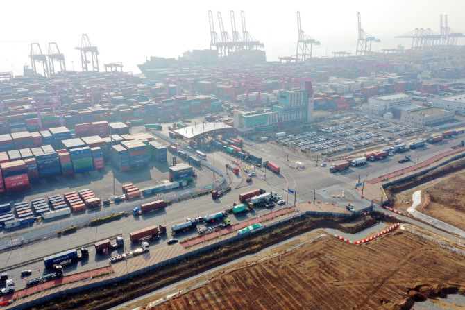 Trucks move into a port in Incheon, on the day truckers voted to end a nationwide strike