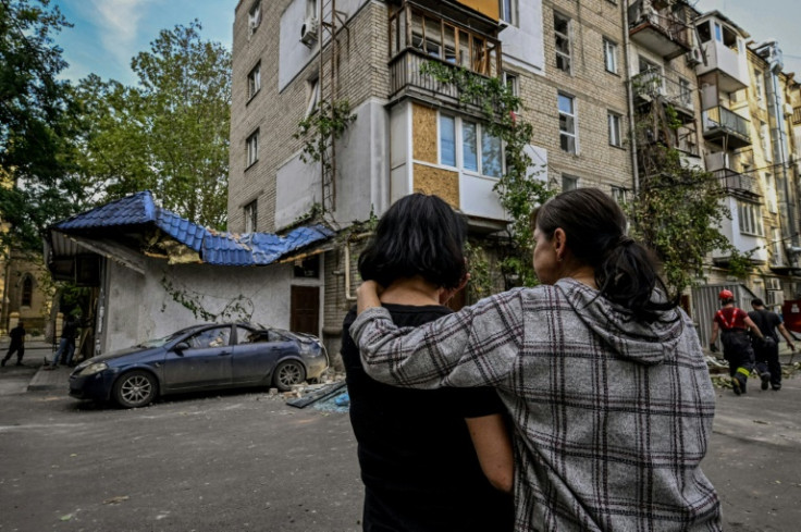 Residents assess the damage after a Russian attack