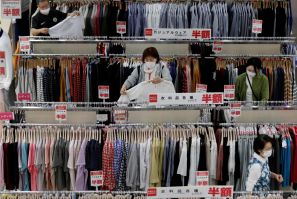 Shoppers wearing protective masks choose clothes at Japan's supermarket group Aeon's shopping mall as the mall reopens amid the coronavirus disease (COVID-19) outbreak in Chiba