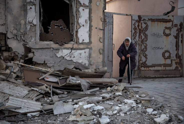 A local resident stands near her house destroyed by a Russian military strike in Kherson