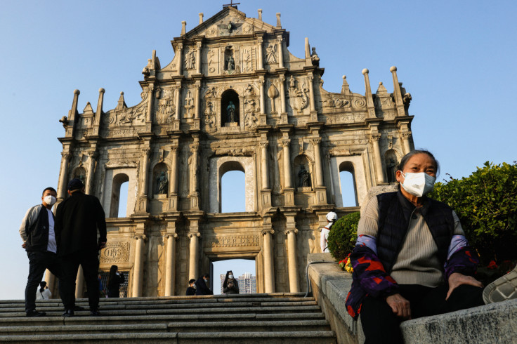 People wearing face masks stand in front of the ruins of Saint Paul's during the coronavirus disease (COVID-19) pandemic in Macau