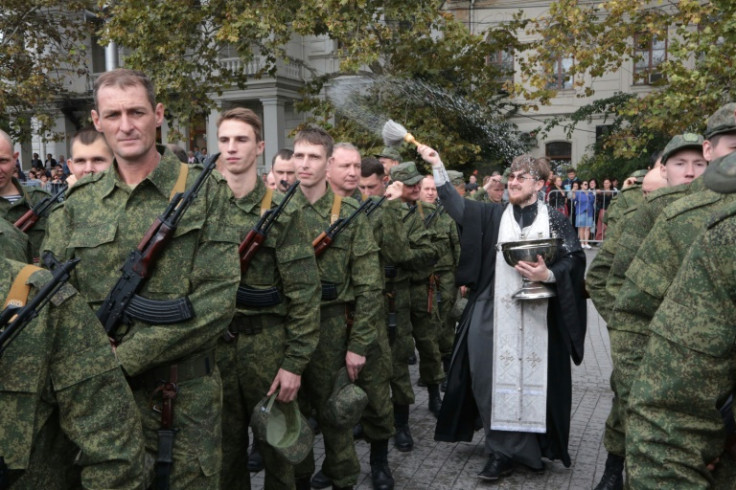 A Russian priest blessing drafted reservists at a departure ceremony in Sevastopol, Crimea, in September 2022