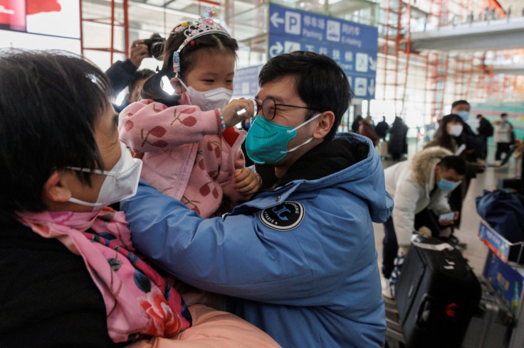 People embrace at the international arrivals gate at Beijing Capital International Airport after China lifted the COVID-19 quarantine requirement for inbound travellers in Beijing