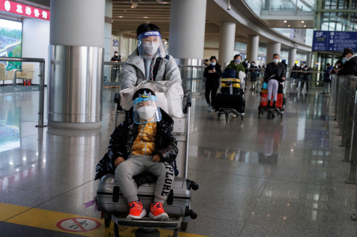 Passengers push their luggage through the international arrivals hall at Beijing Capital International Airport after China lifted the COVID-19 quarantine requirement for inbound travellers in Beijing