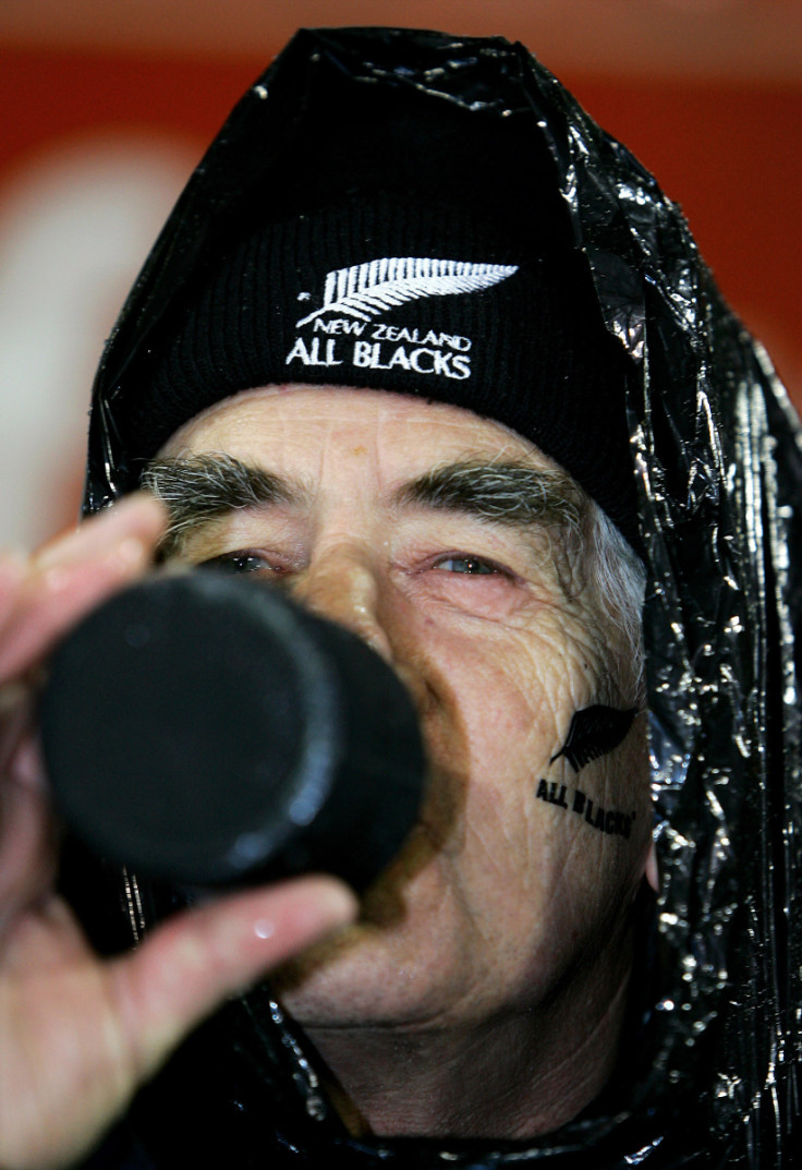 All Black supporter drinks beer as he sits in rain before first test against British and Irish ...