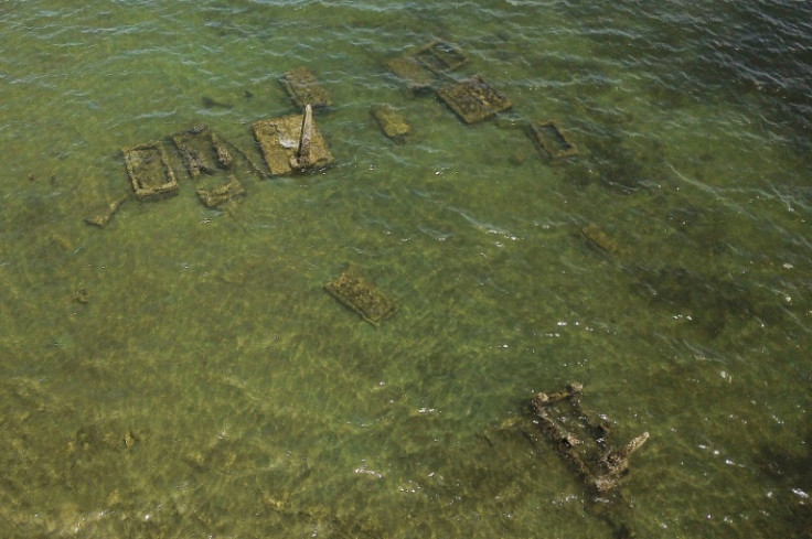 Submerged tombs in a village graveyard, now underwater due to the effects of climate change, in Togoru