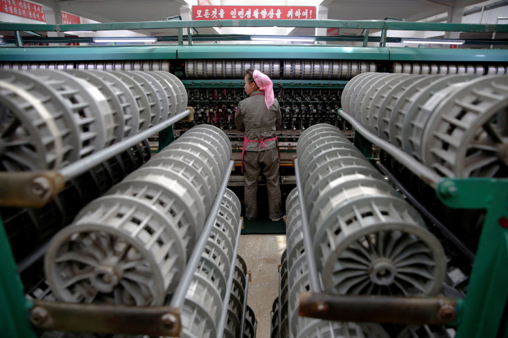 A woman works at the Kim Jong Suk Pyongyang textile mill during a government organised visit for foreign reporters in Pyongyang