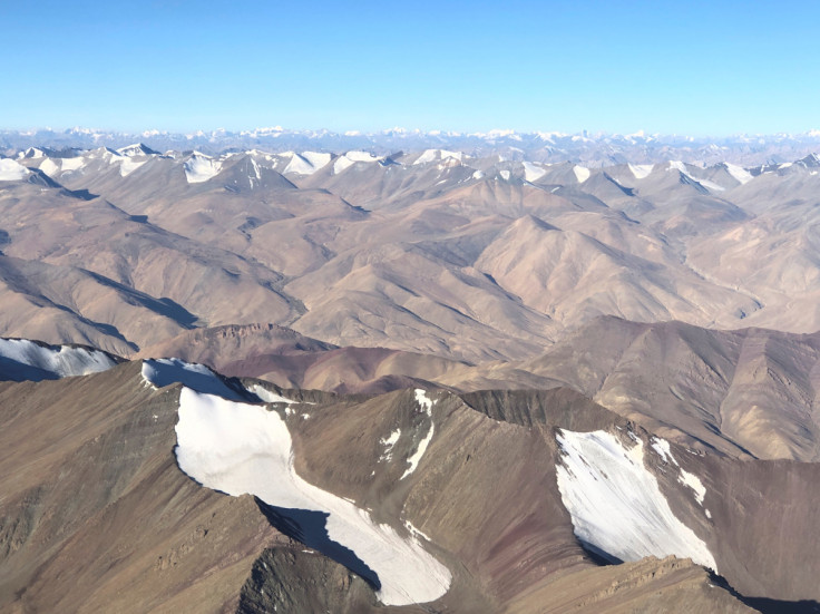 Snow-covered mountain range is seen from a passenger airplane in Ladakh region