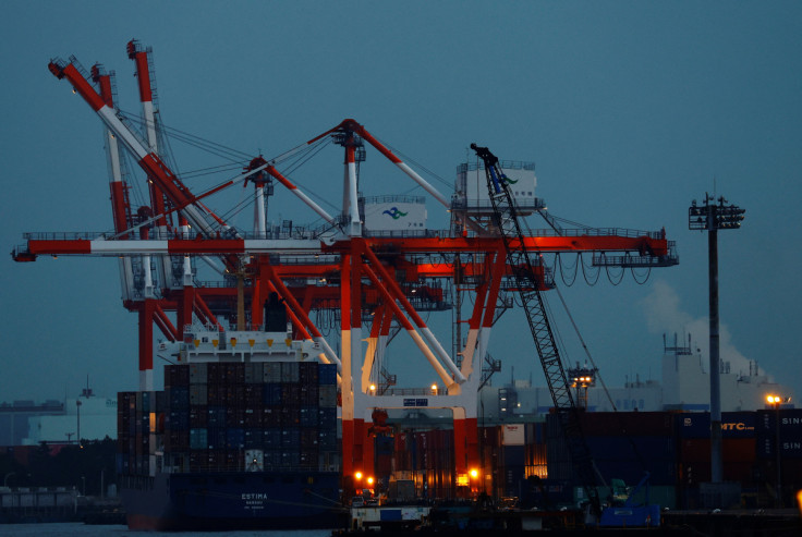A cargo ship and containers are seen at an industrial port in Tokyo