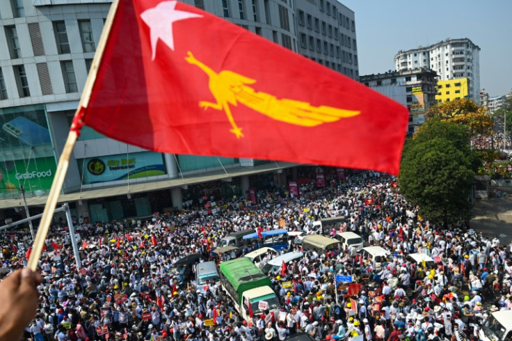 An NLD flag is waved during a protest against the coup in February 2021. With the political opposition now decimated, the junta is expected to hold elections later this year