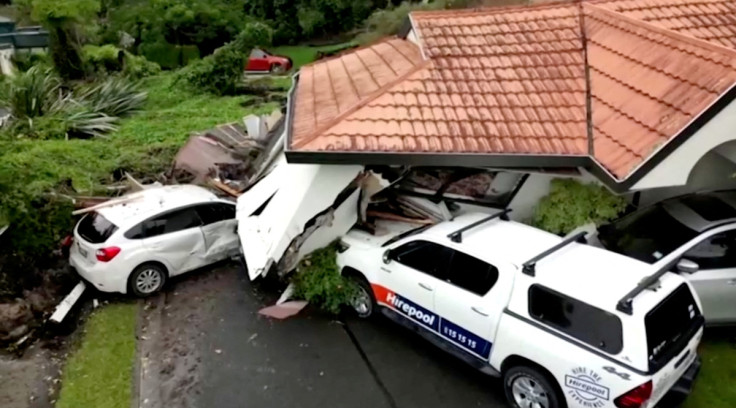 A view of a house that had collapsed on vehicles, following floods, in Auckland