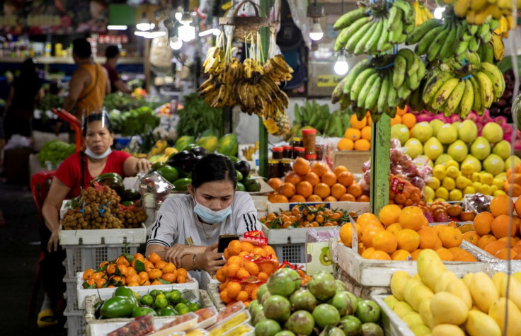 Vendors wearing face masks for protection against the coronavirus disease (COVID-19) stand by their fruit stalls at a public market in Quezon City, Metro Manila, Philippines, February 5, 2021. 