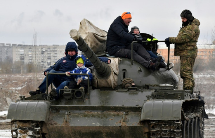 Visitors ride a Soviet tank at a military-themed amusement park near St Petersburg