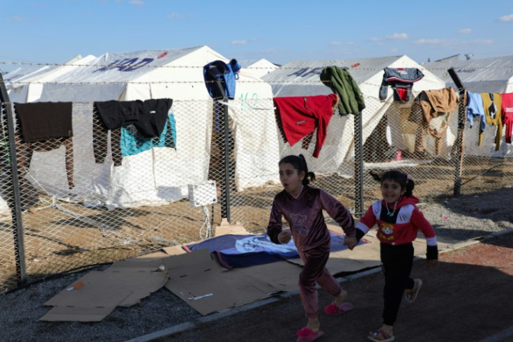 Displaced Syrian children play among tents in a camp set up to house survivors who have lost everything