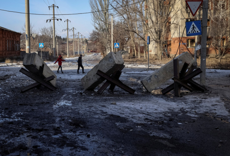 Local residents walk on an empty street in Bakhmut