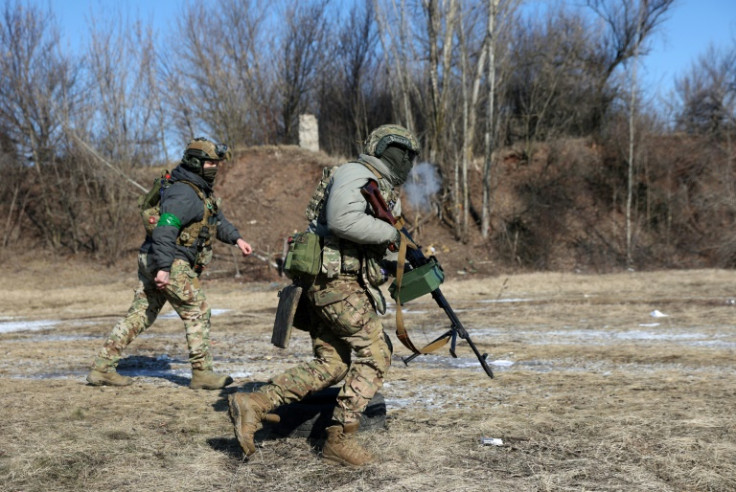 Ukrainian servicemen train in the Kharkiv region on the first anniversary of the Russian invasion