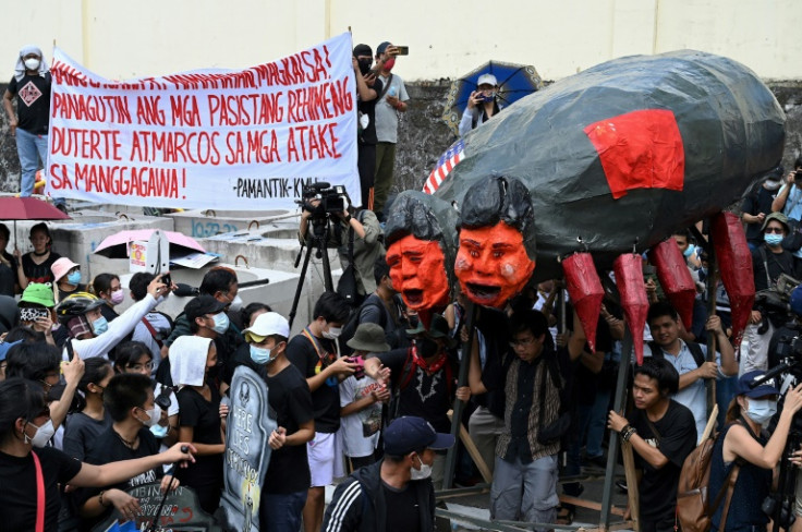 Protesters carry an effigy of Philippine President Ferdinand Marcos Jr and former president Rodrigo Duterte