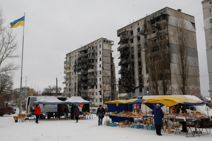 Local residents buy food at a street market in Borodianka