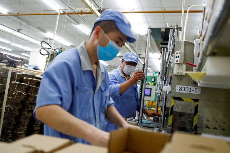 Employees wearing masks work at a factory of the component maker SMC during a government organised tour of its facility following the outbreak of the coronavirus disease (COVID-19), in Beijing