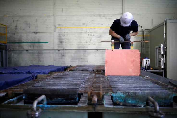 An employee holds a recycled copper plate at an urban mining plant in Gunsan