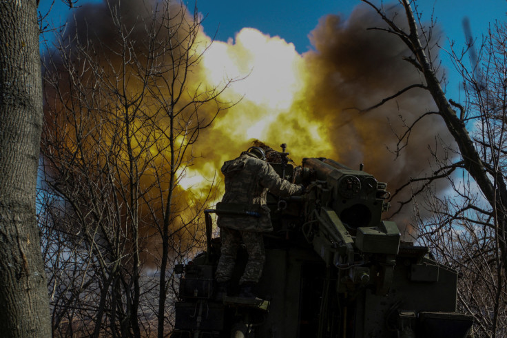 Ukrainian servicemen fire a 2S5 Giatsint-S self-propelled howitzer towards Russian troops outside the frontline town of Bakhmut