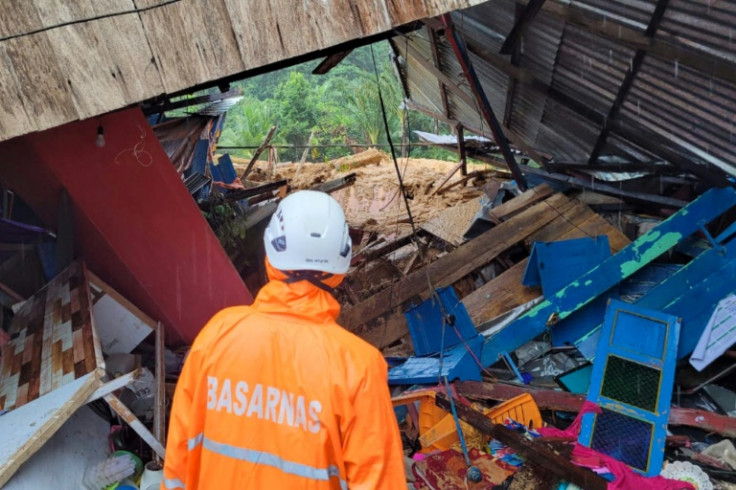 Rescuers are searching buried homes for more than 40 people still missing after a landslide on a remote Indonesian island