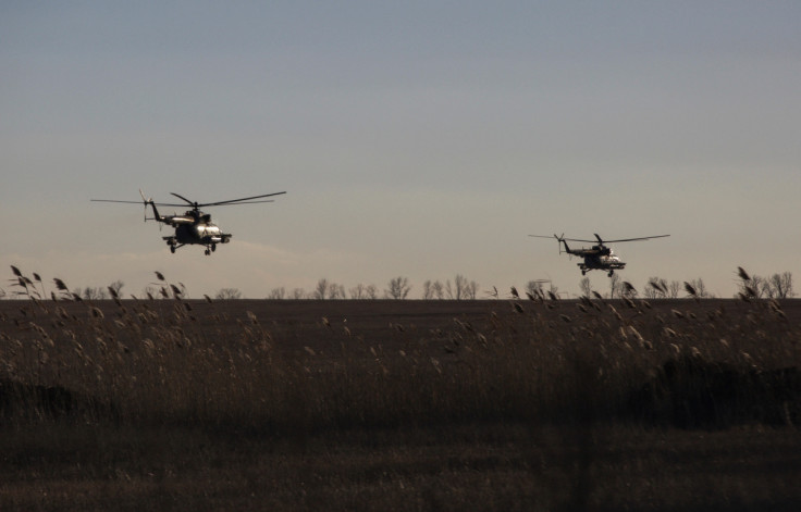 Ukrainian Armed Forces helicopters fly over a field outside the frontline town of Bakhmut