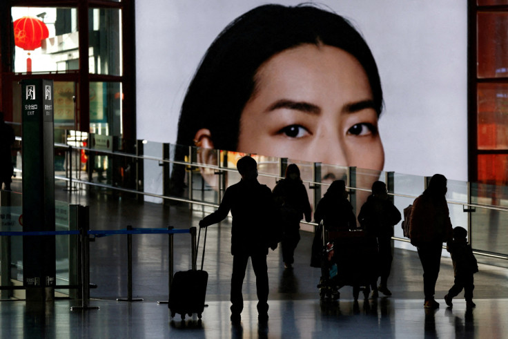 Travellers walk during the annual Spring Festival travel rush at Beijing Capital International Airport