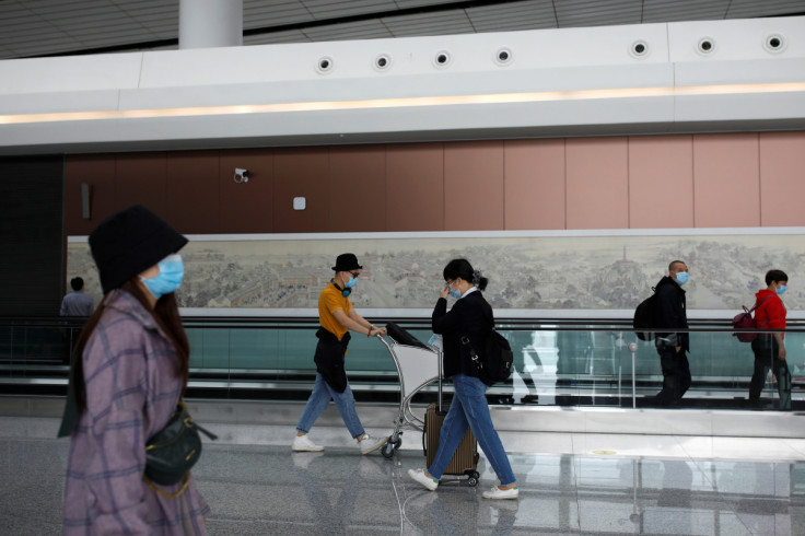 Passengers wearing face masks following the coronavirus disease (COVID-19) outbreak walk at the Beijing Daxing International Airport ahead of Chinese National Day holiday, in Beijing
