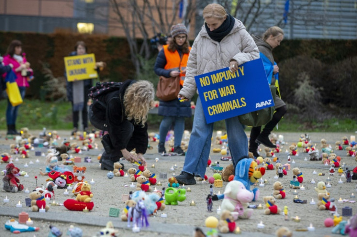 An epxanse of dolls and toys laid out during a February 2023 protest in Brussels over alleged Ukrainian child abductions by Russian forces