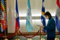 A woman walks past a Honduras flag (C) at Taiwan's Ministry of Foreign Affairs in Taipei