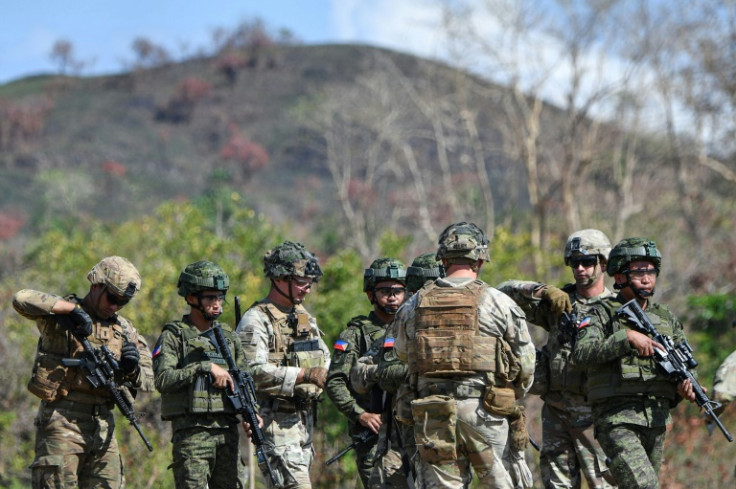 US and Philippine soldiers walk during a joint army-to-army exercise at Fort Magsaysay, Nueva Ecija province on March 31, 2023