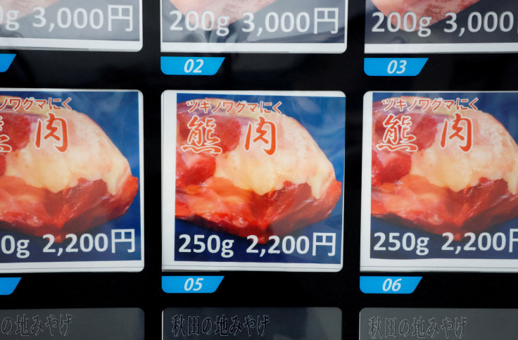 A display screen of a vending machine for placing the order for Asian Black Bear meat is seen in front of a Soba Noodle restaurant in Semboku