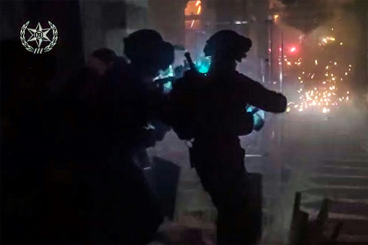This image grab from a video released by the Israeli police on April 5, 2023 shows footage of what they say are Palestinians throwing fireworks at Israeli forces inside al-Aqsa Mosque in the old city of Jerusalem