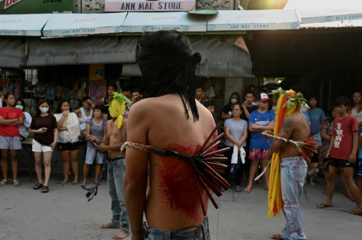 Penitents flagellate themselves on Good Friday as part of Holy Week celebrations in the Philippines