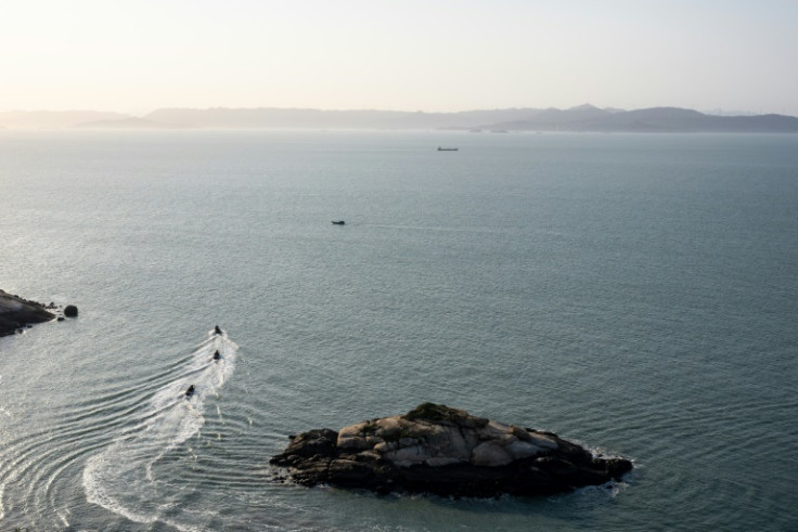 Taiwanese military boats patrol the Matsu islands with a view of China's Fujian province in the background