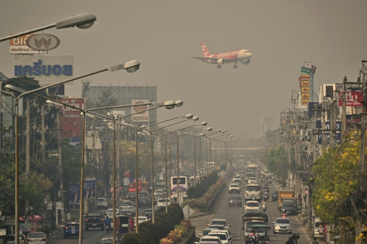 An Air Asia plane descends towards Chiang Mai International Airport amid high levels of air pollution