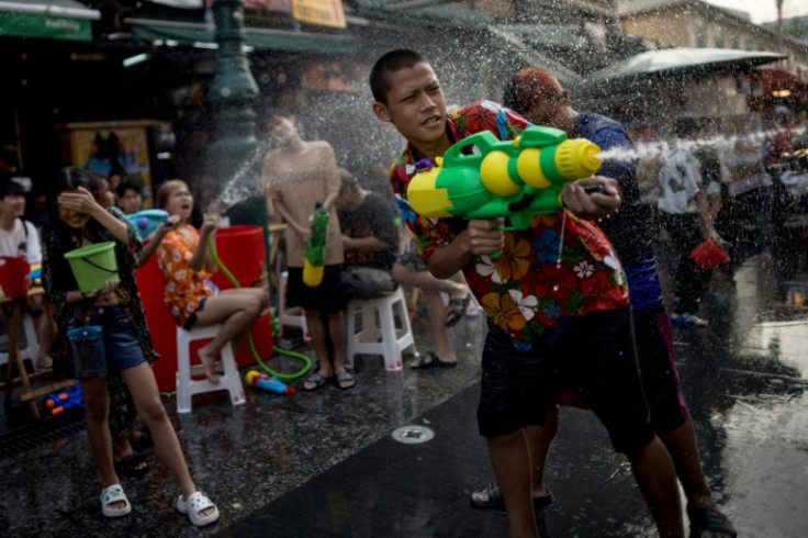 At either end of the street stalls selling water pistols, protective plastic phone covers, and 20-baht (60 US cents) water refills were doing a brisk trade