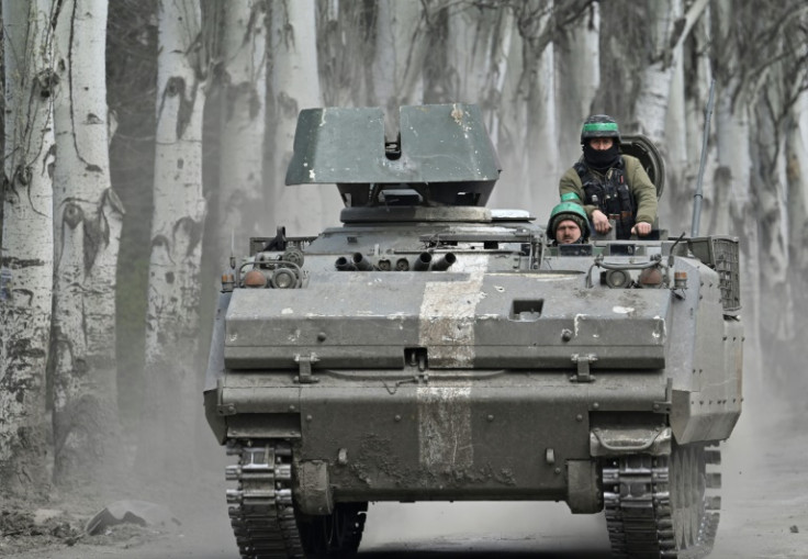Ukrainian servicemen ride on a YPR-765 armoured personnel carrier near Bakhmut