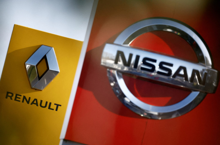 The logos of car manufacturers Nissan and Renault are seen in front of dealerships