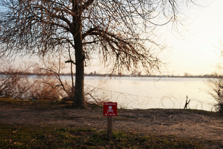 A view of a mine danger sign in front of Dnipro river, in Kherson