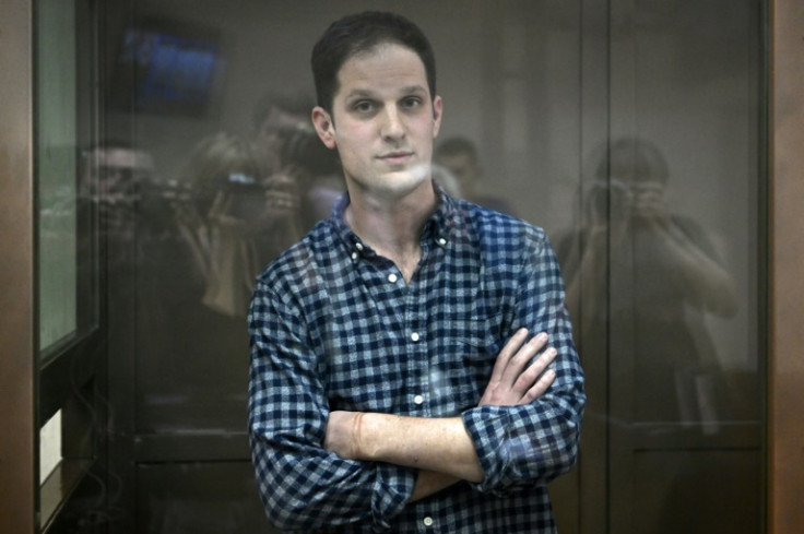 US journalist Evan Gershkovich, arrested on espionage charges, stands inside a defendants' cage before a hearing to consider an appeal on his arrest at the Moscow City Court in Moscow on April 18, 2023
