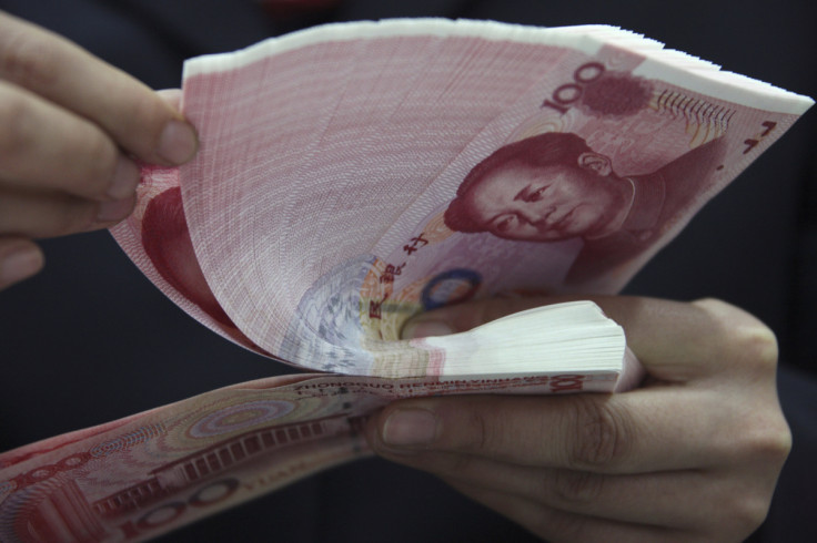 An employee counts yuan banknotes at a branch of Industrial and Commercial Bank of China (ICBC) in Huaibei,