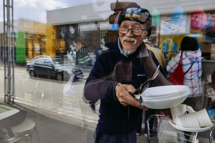 Humanitarian volunteer  Fuminori Tsuchiko from Japan looks through a window of his cafe in Kharkiv