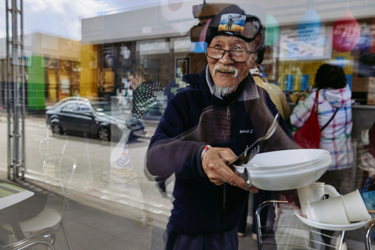 Humanitarian volunteer Fuminori Tsuchiko from Japan looks through a window of his cafe in Kharkiv
