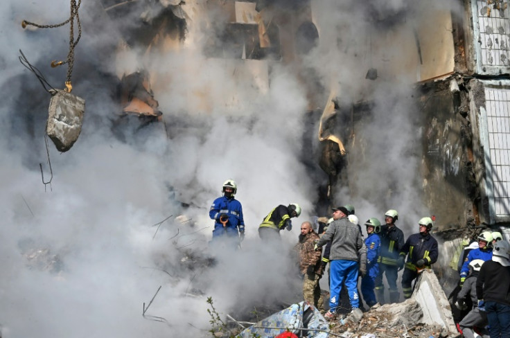 Rescuers search for survivors in the rubble of a damaged building