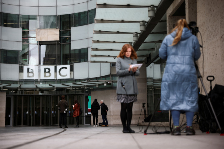 Members of the media work outside the BBC headquarters, in London